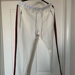 Track pants, off white with red green stripes.